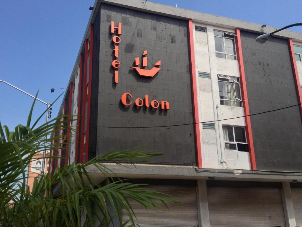 a building with a clock on the side of it at Hotel Colon Express in Guadalajara