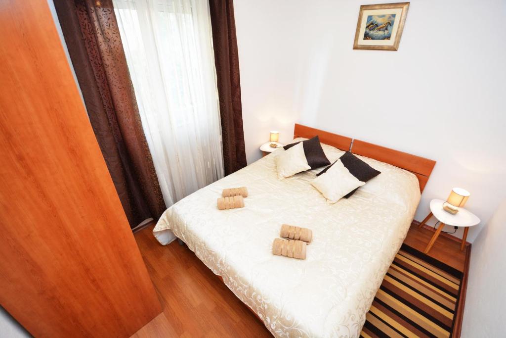 a bedroom with a bed with two pillows on it at Apartment Zita in Zadar