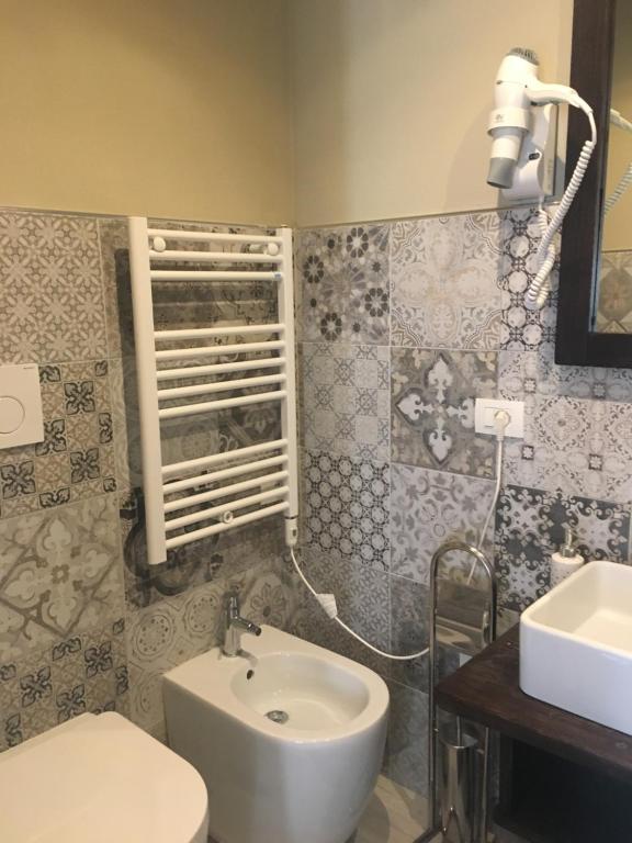 a bathroom with a white sink and a toilet at Casa D'amore in Riomaggiore