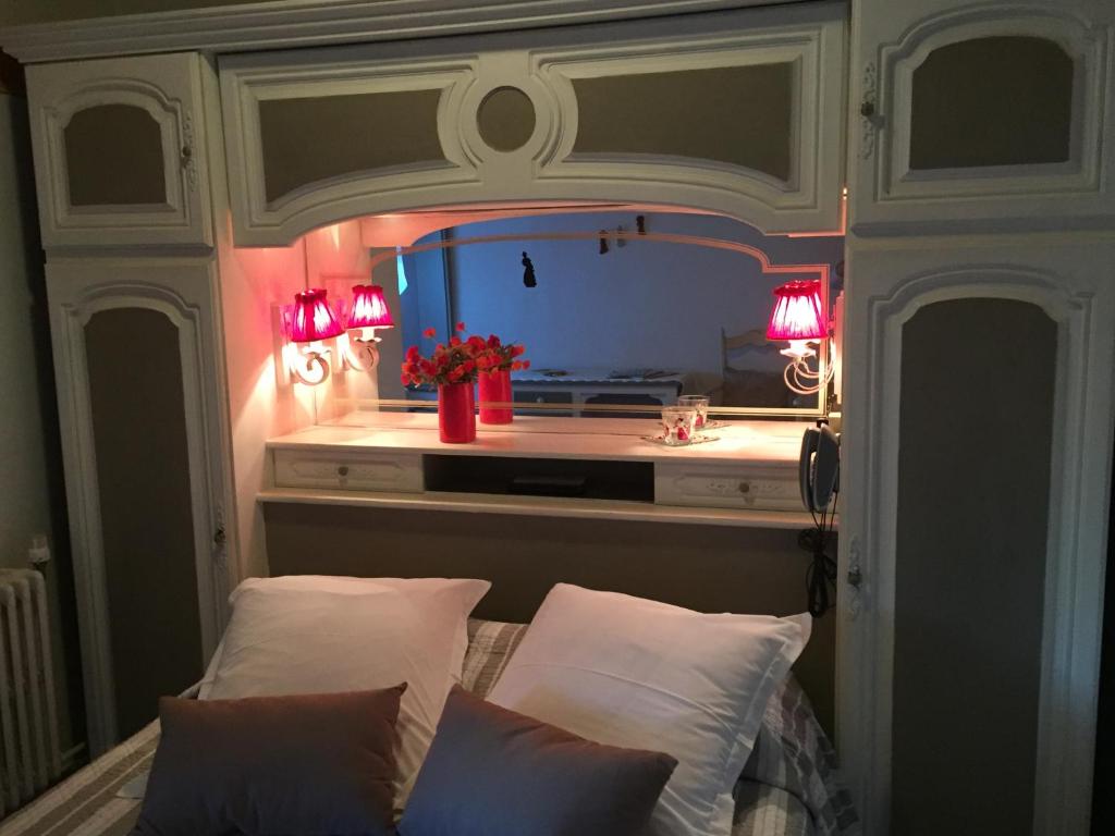 a bedroom with a bed with two white pillows at Hotel Le Méditérranée in Saintes-Maries-de-la-Mer