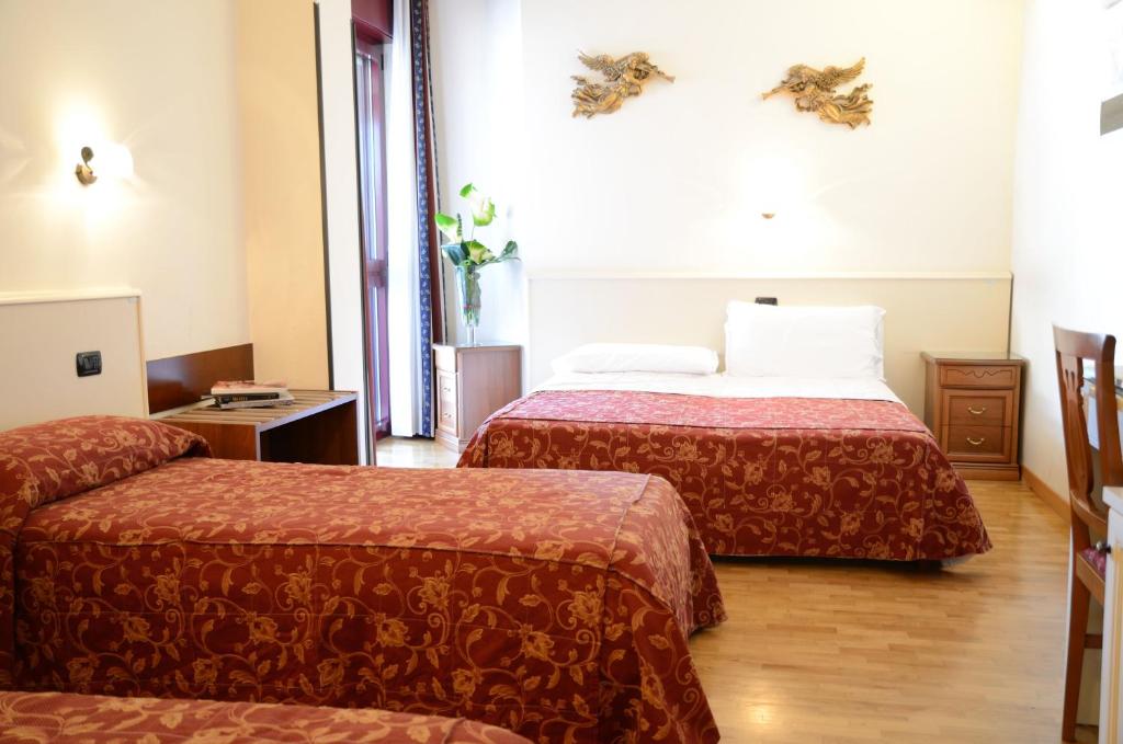 Łóżko lub łóżka w pokoju w obiekcie Hotel HDomus