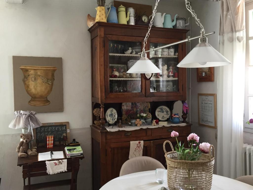 a dining room with a table and two lights at Hotel Le Méditérranée in Saintes-Maries-de-la-Mer