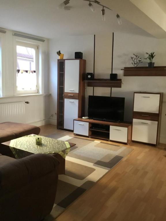 a living room with a couch and a television at Ferienwohnung Misch in Eschwege