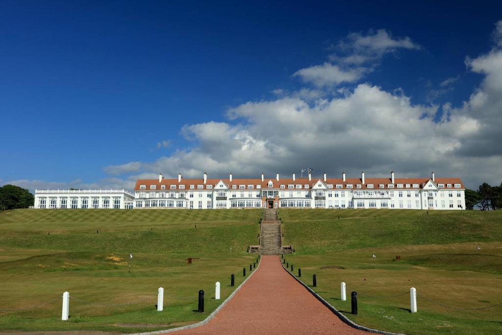 a large white building with a red roof at Trump Turnberry in Turnberry