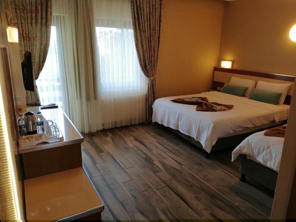 Postel nebo postele na pokoji v ubytování Iris Hotel & Spa