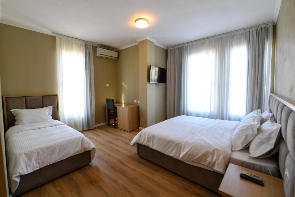 Säng eller sängar i ett rum på SANTO Hotel