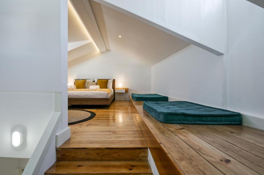 a living room with a couch and a bed in it at Hip Tailor Made Duplex Penthouse in Bairro Alto in Lisbon