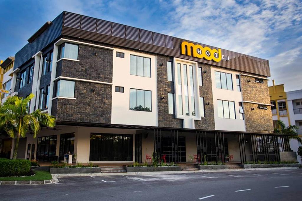 a building with a hotel sign on top of it at Mood Hotel in Skudai