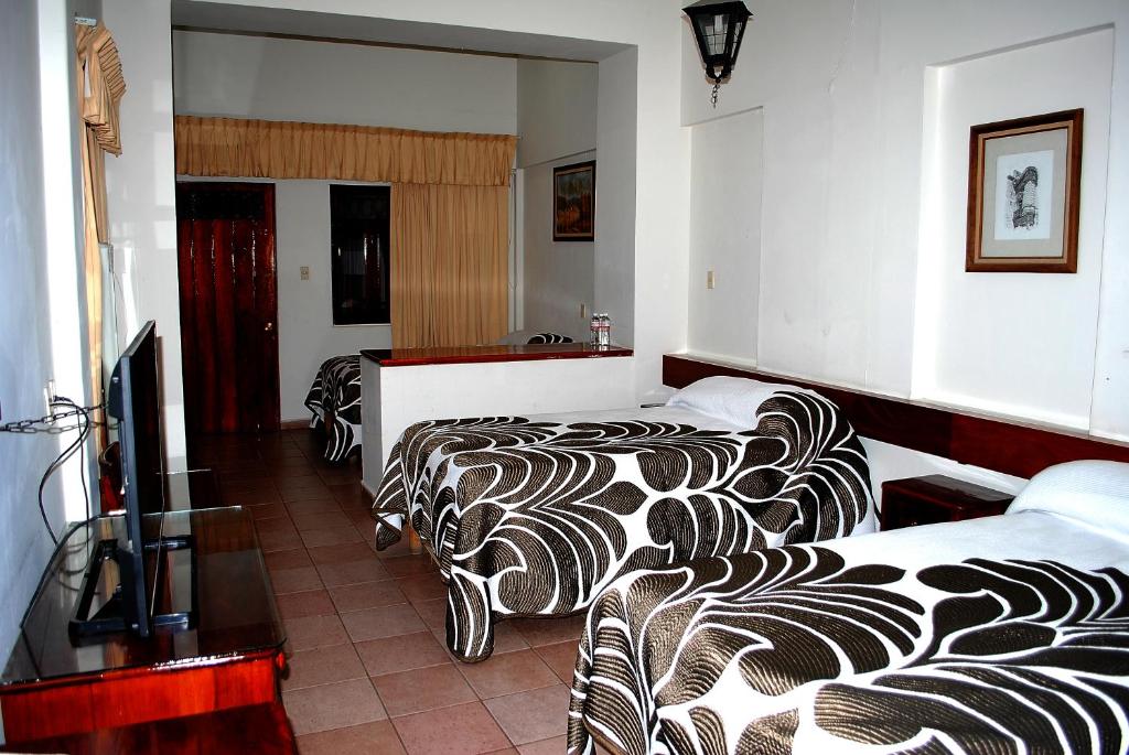Postel nebo postele na pokoji v ubytování HOTEL POSADA DEL SOL