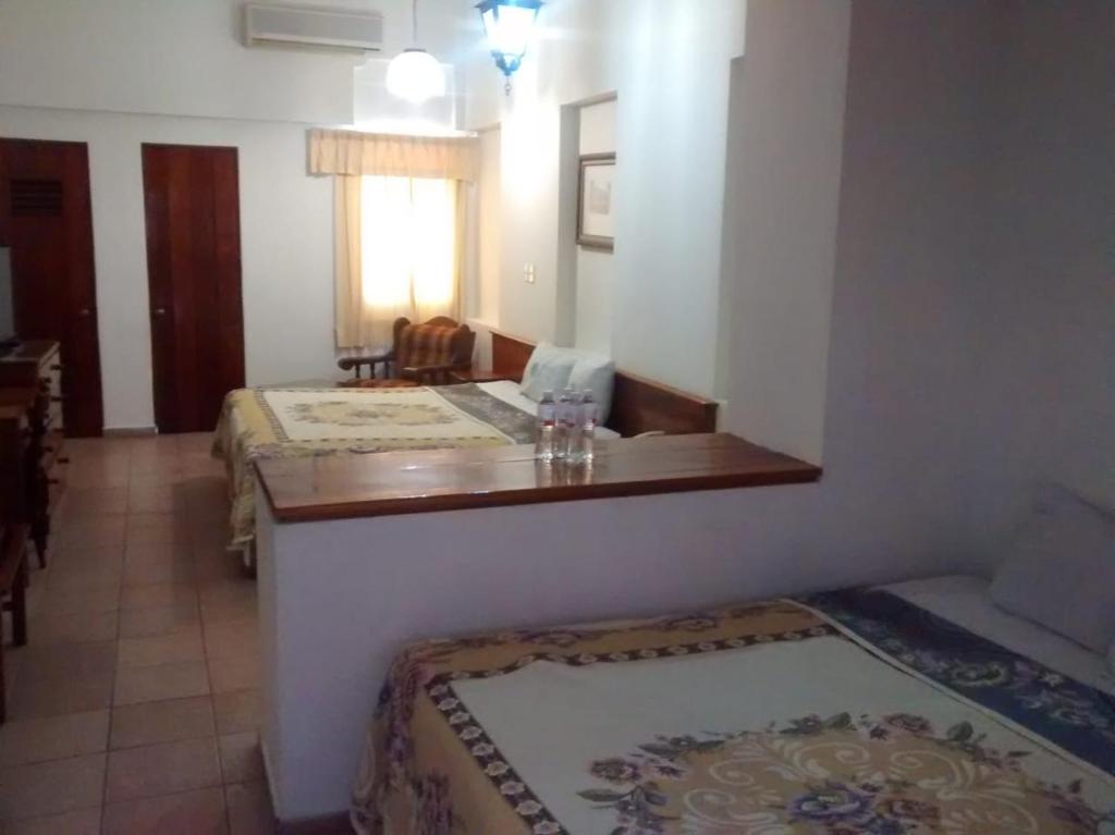 Postel nebo postele na pokoji v ubytování HOTEL POSADA DEL SOL