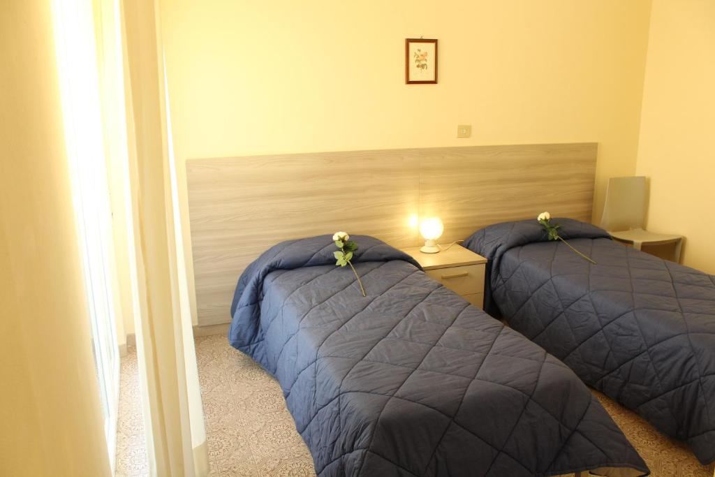 Postel nebo postele na pokoji v ubytování Hotel Luca