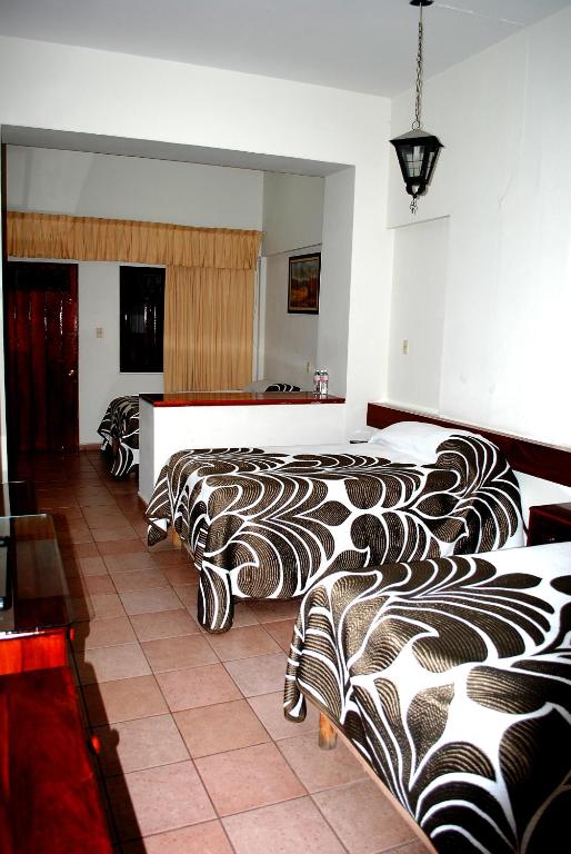 Postel nebo postele na pokoji v ubytování HOTEL POSADA DEL SOL