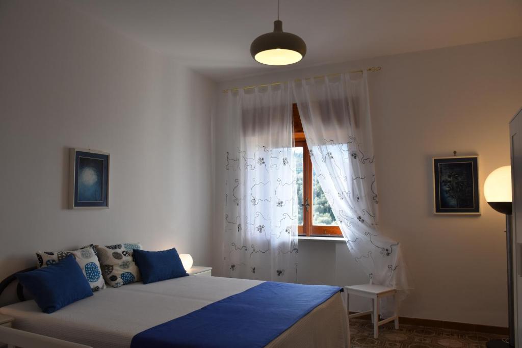 a bedroom with a bed and a window at De Gregorio in Massa Lubrense