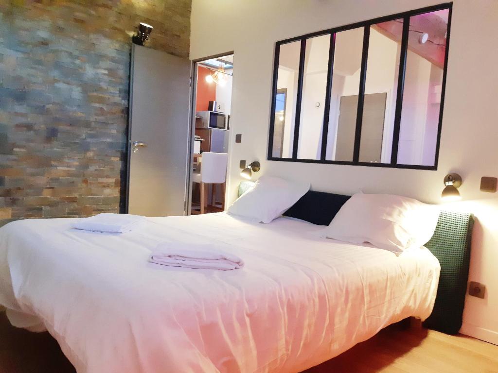 Un pat sau paturi într-o cameră la Chez Muriella & Marco