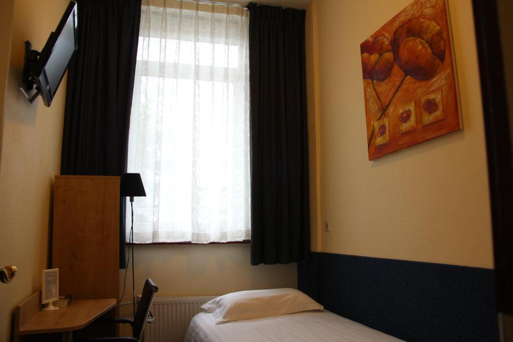 TV a/nebo společenská místnost v ubytování New City Hotel Scheveningen