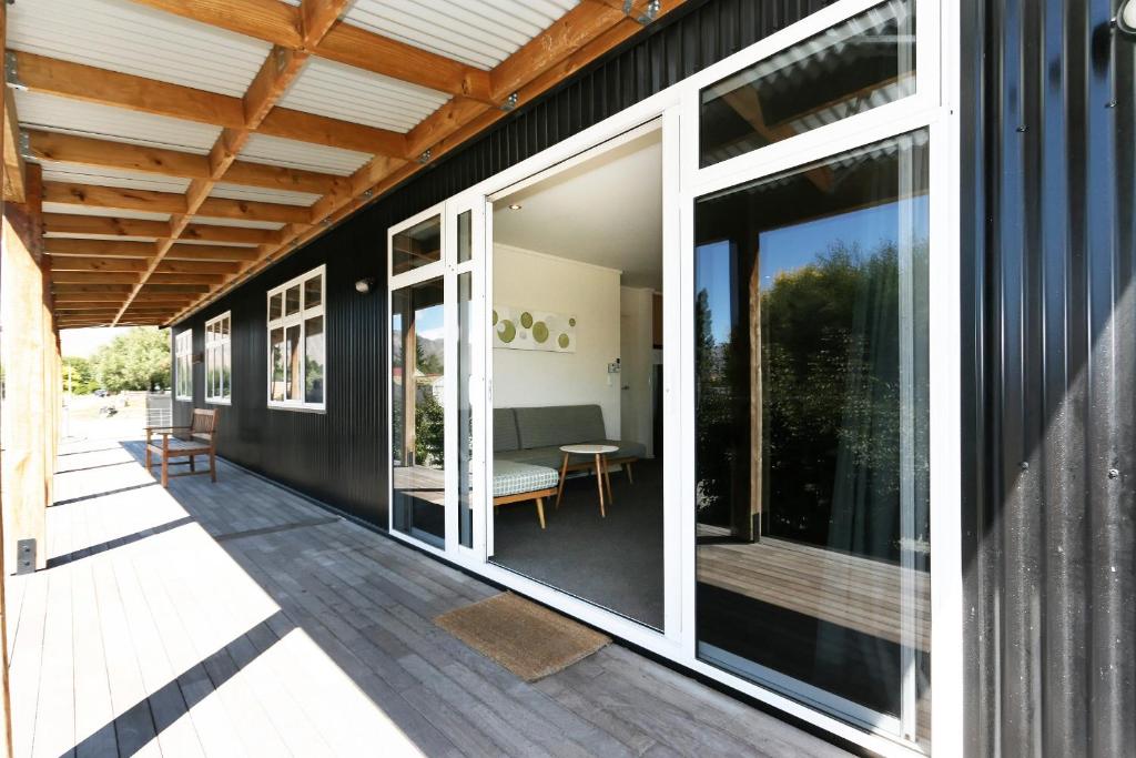 a screened porch with sliding glass doors on a house at Matagouri Cottage - Lake Tekapo in Lake Tekapo