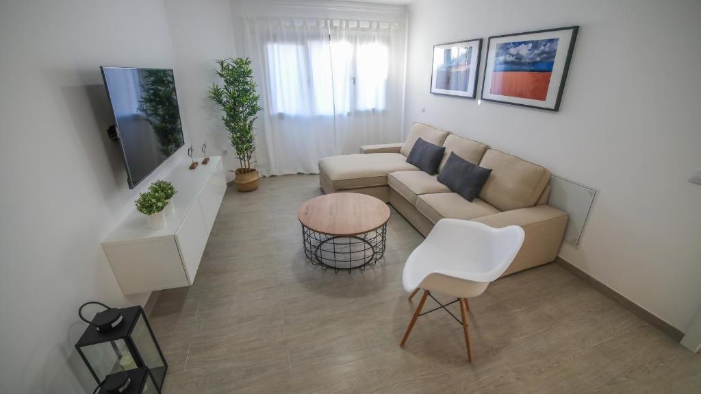 a living room filled with furniture and a tv at Brazan Holidays in Corralejo
