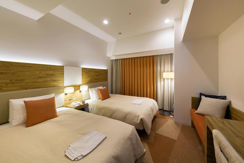 Postel nebo postele na pokoji v ubytování Sotetsu Fresa Inn Nagano-Zenkojiguchi