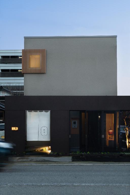 a black building with a window with the number on it at 礎旅音 in Kanazawa