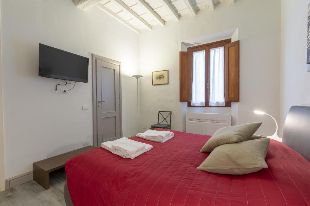 Posteľ alebo postele v izbe v ubytovaní Ponte Vecchio's Nest