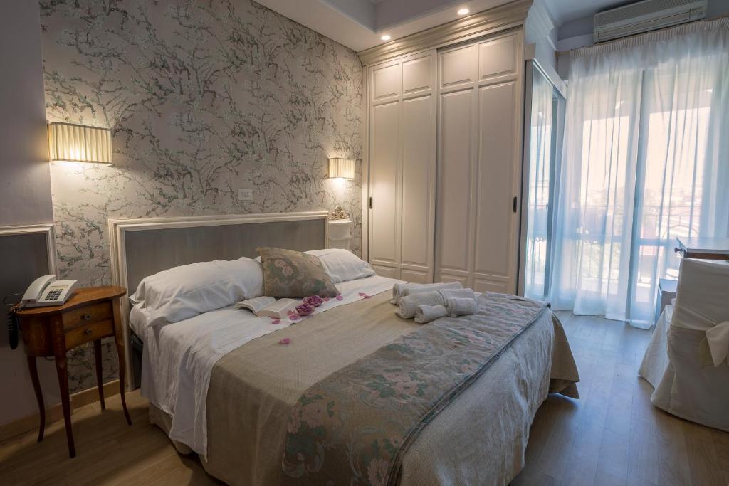 a bedroom with a bed with a teddy bear on it at Hotel Mocambo piscina e spiaggia in San Benedetto del Tronto