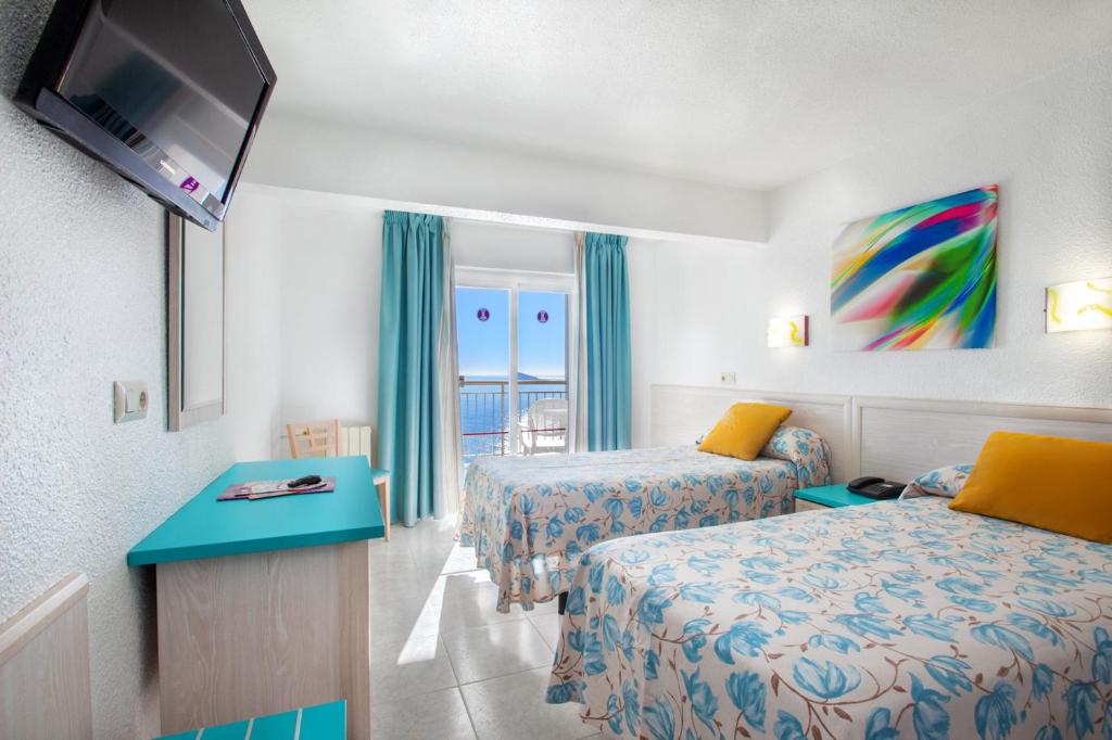 Postel nebo postele na pokoji v ubytování Hotel Servigroup Torre Dorada