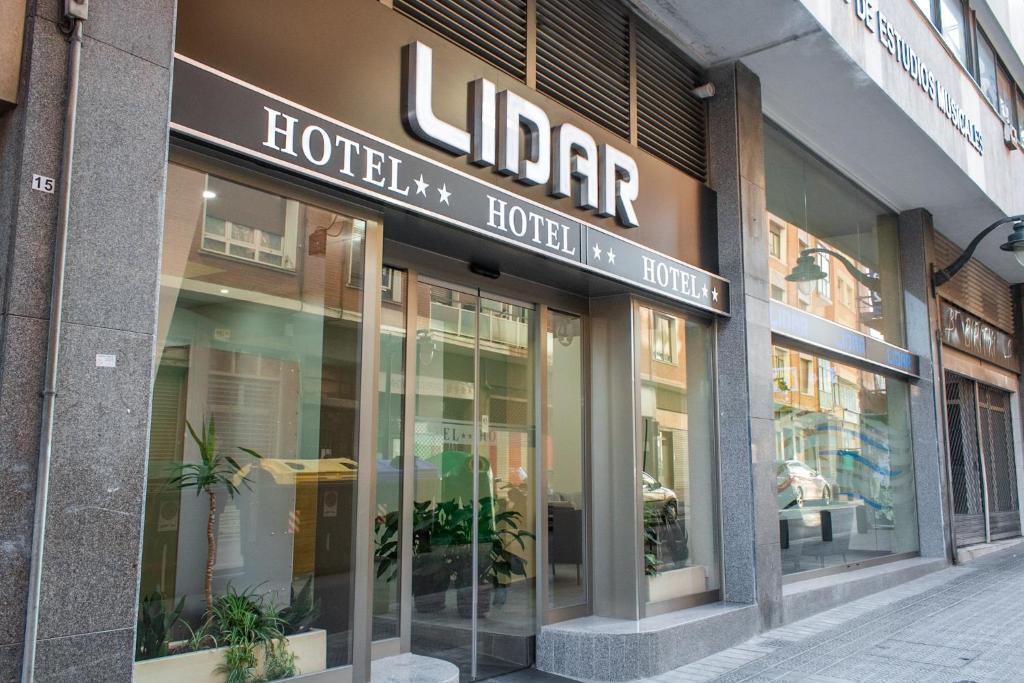 a store front of a hotel with glass windows at Hotel Lidar in Bilbao