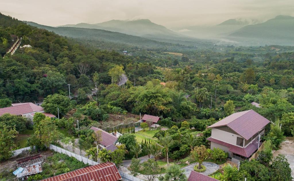 an aerial view of a house in a forest at Thanburi resort in Chom Thong