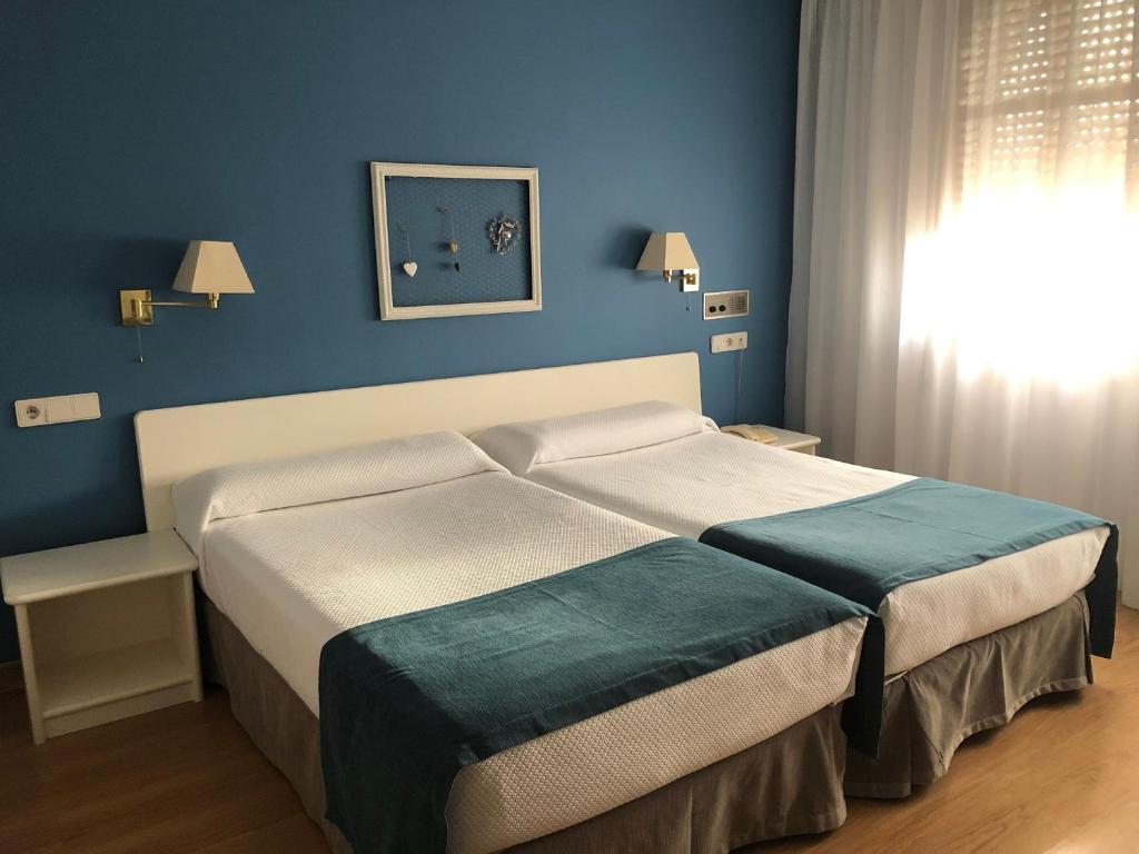 Postel nebo postele na pokoji v ubytování Hotel Jakue
