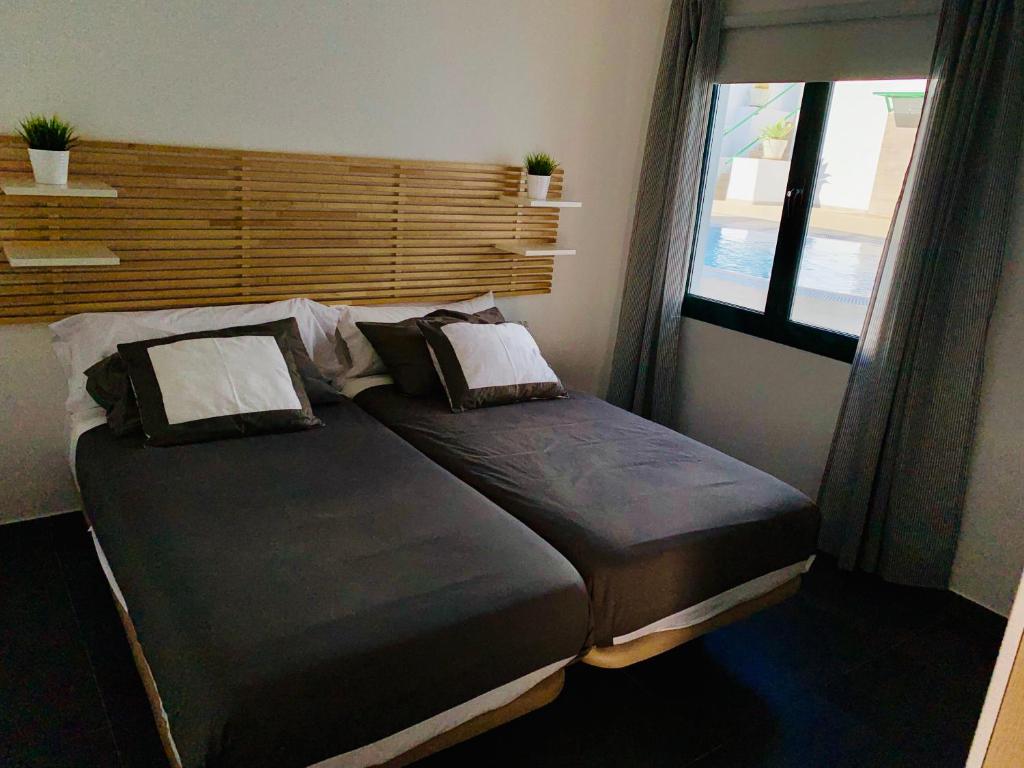 Postel nebo postele na pokoji v ubytování Apartamentos Zalabar
