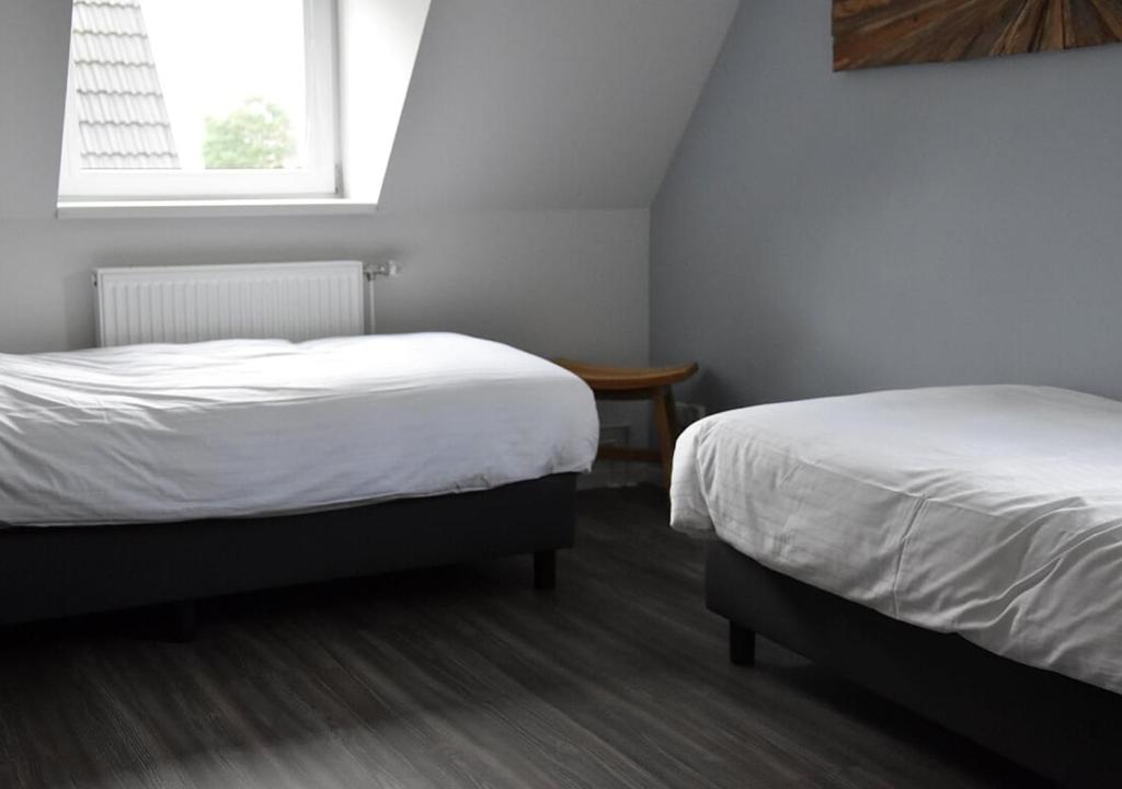 Postel nebo postele na pokoji v ubytování Waterdorp Burdaard