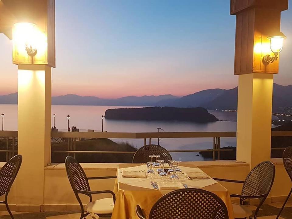 a table and chairs with a view of the water at Hotel Villa Principe in San Nicola Arcella
