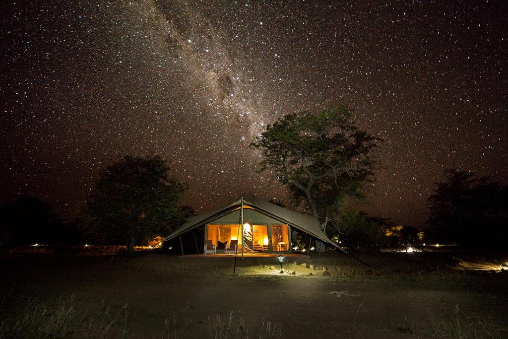 a tent under a night sky with the milky way at Malansrus in Twyfelfontein