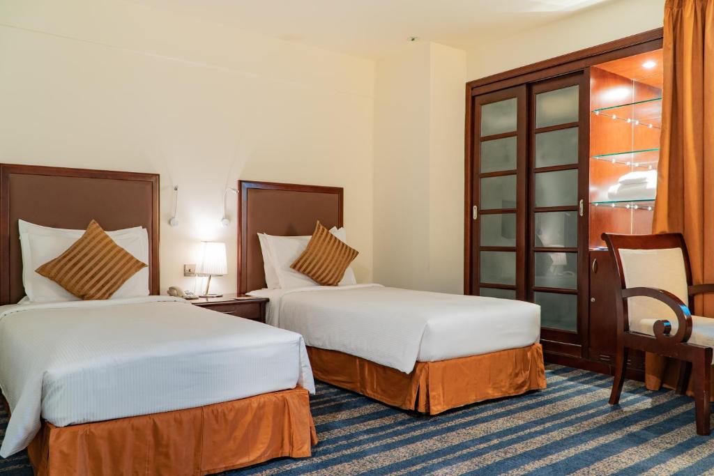 Postel nebo postele na pokoji v ubytování Al Ain Palace Hotel Abu Dhabi