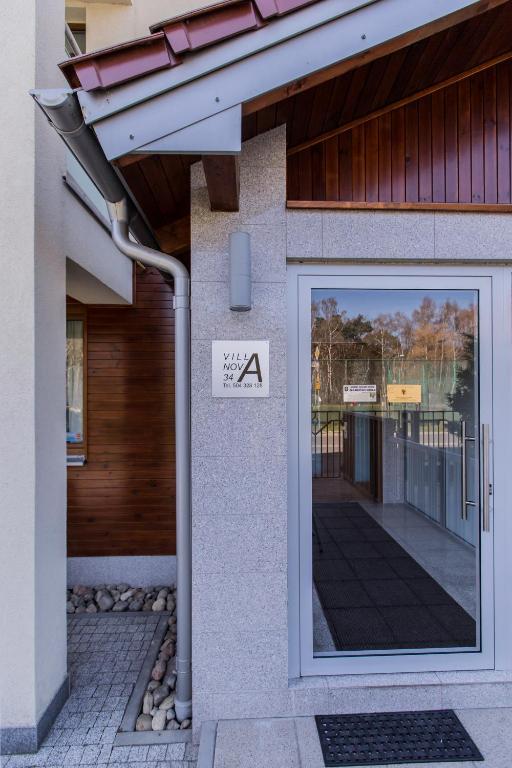 a door to a building with a sign on it at Villa Nova 34A in Hel