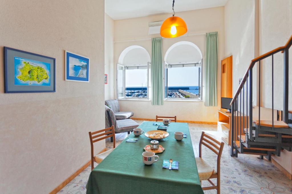 a living room with a green table and chairs at Casa Vacanze Parco Del Generale in Ischia