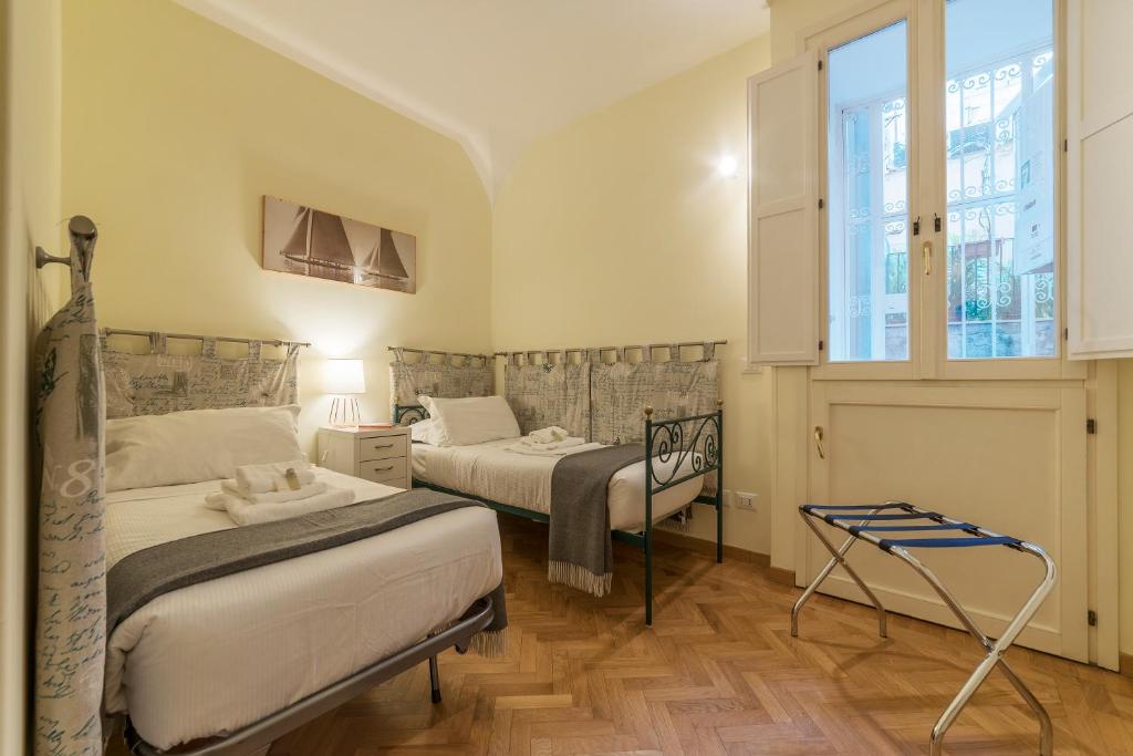 A bed or beds in a room at Casa Cornacchie - FromHometoRome