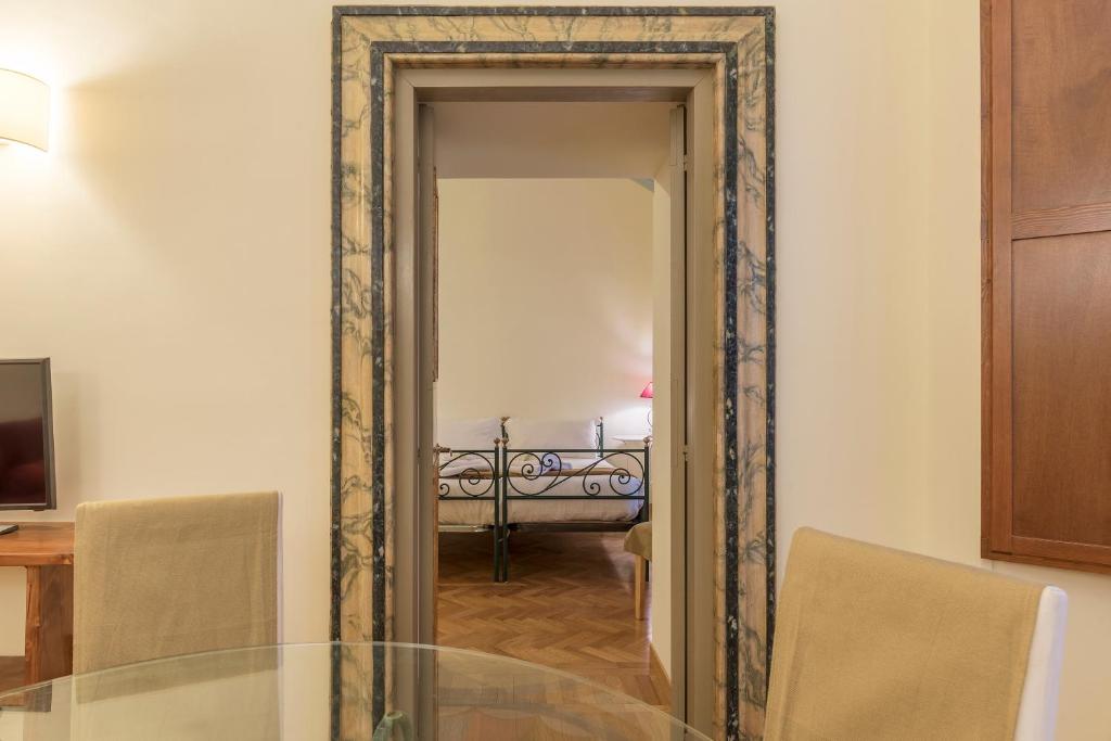 A bed or beds in a room at Casa Cornacchie - FromHometoRome