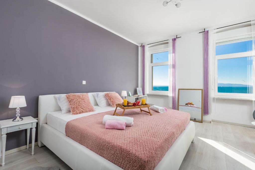 a white room with a bed with a table at Apartment Lucia in Rijeka