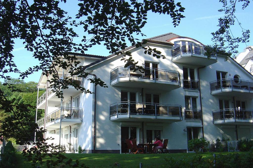 a large white building with people sitting on the balconies at Residenz Falkenberg by Rujana in Ostseebad Sellin