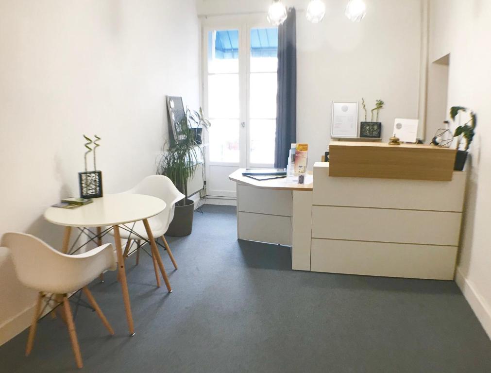 an office with a desk and a table and chairs at Hotel De La Poste in Ganges