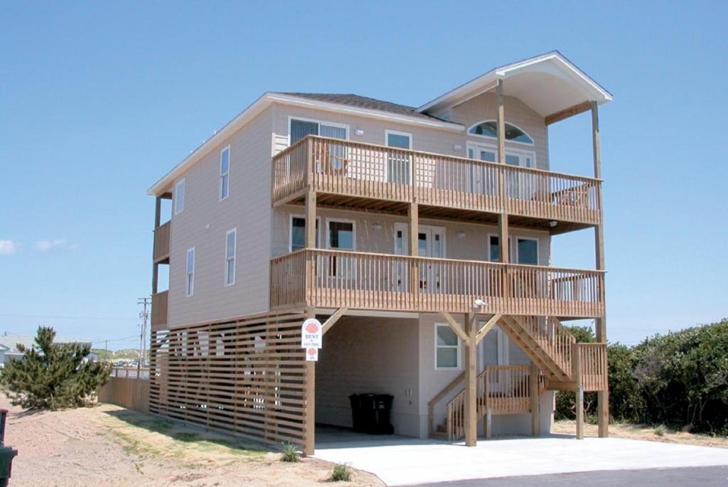 a large house with balconies on a beach at Shell Town in Nags Head