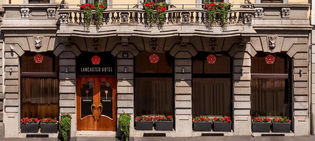 a building with flowers in front of a door at Lancaster Hotel in Milan