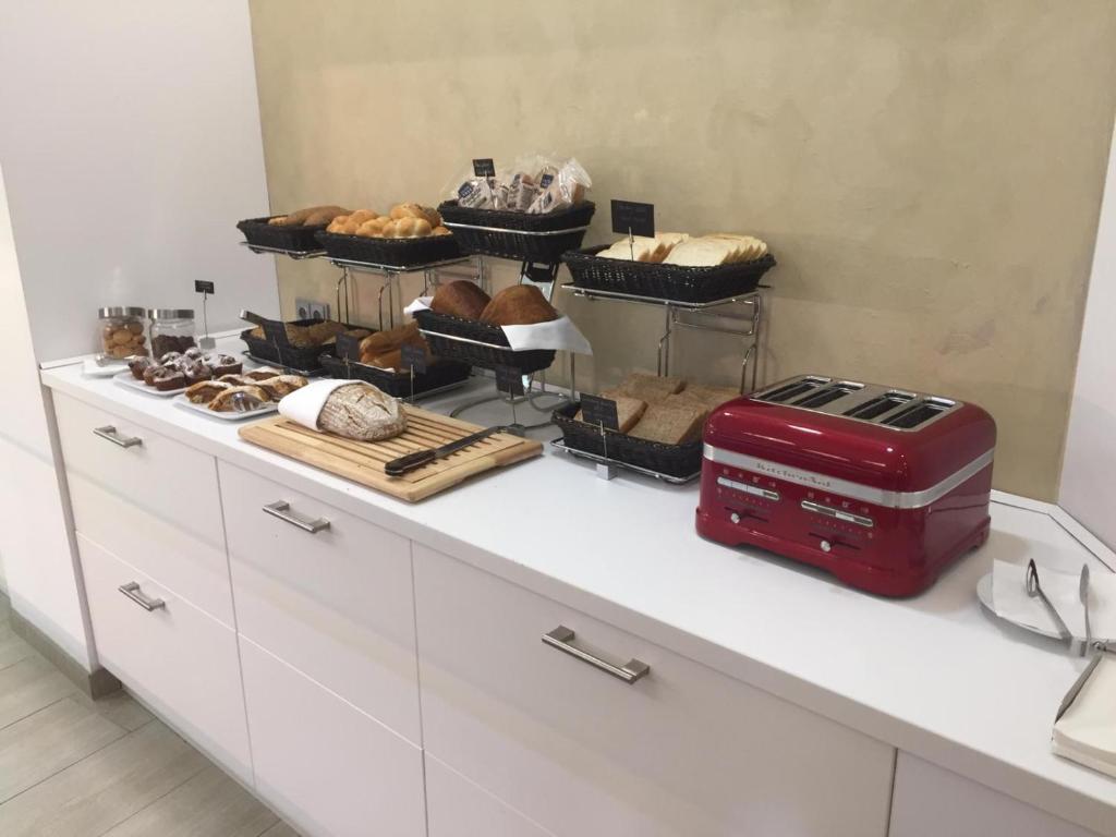a kitchen counter with bread and other foods on it at Hotel Galatea in Mladá Boleslav
