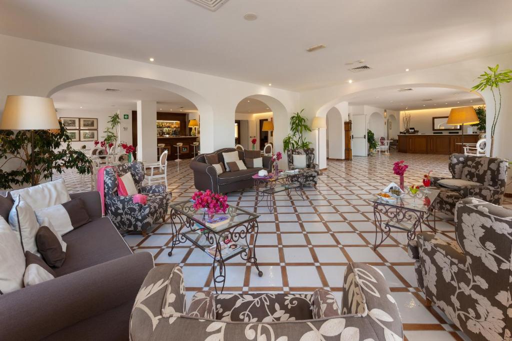 a large living room with couches and tables at Hotel Alpha in Sant'Agnello