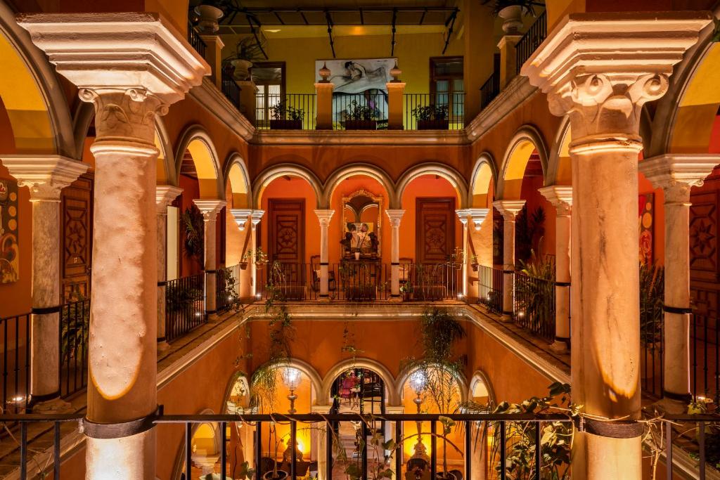a large building with columns and a staircase in it at Hotel Casa Del Poeta in Seville
