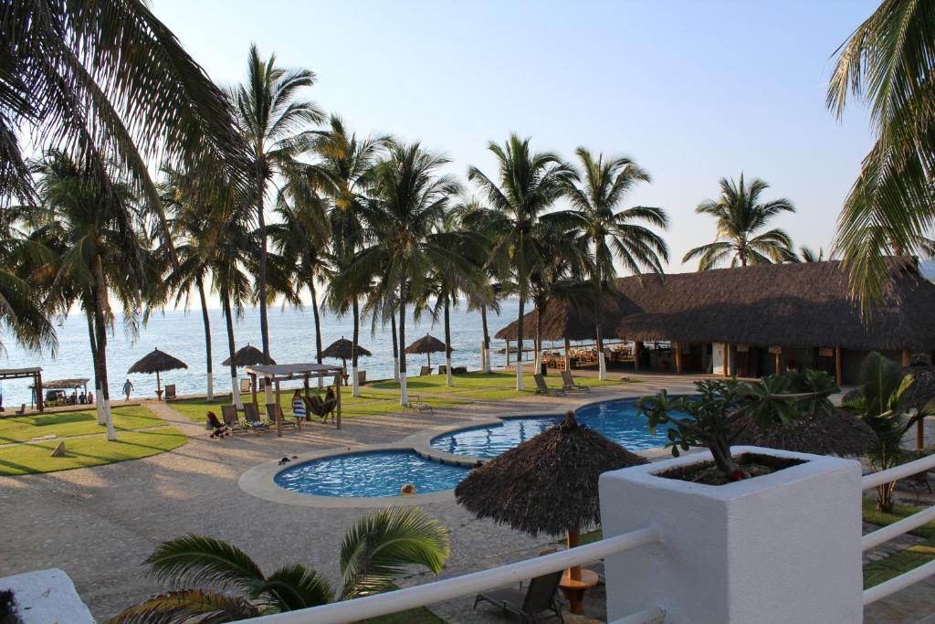 a view of a resort with a pool and palm trees at Hotel Mayto in Ipala