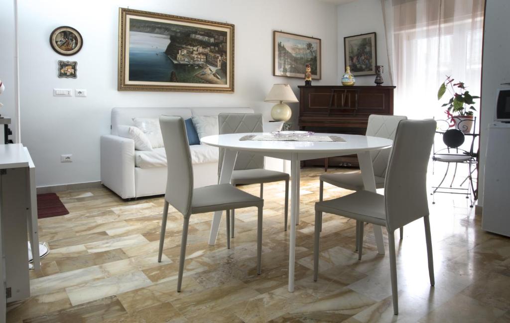 a living room with a white table and chairs at La maison de Julie in Vico Equense