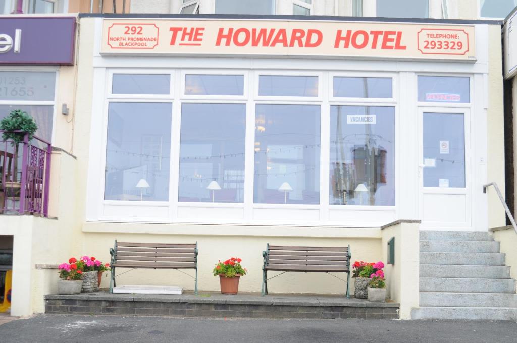 two benches sitting in front of a hotel at Howard Hotel in Blackpool