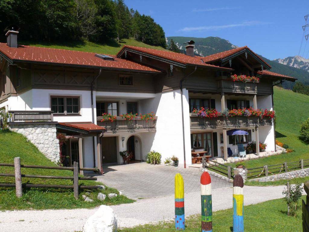 a house with flowers on the balconies of it at Haus Eicher in Schneizlreuth